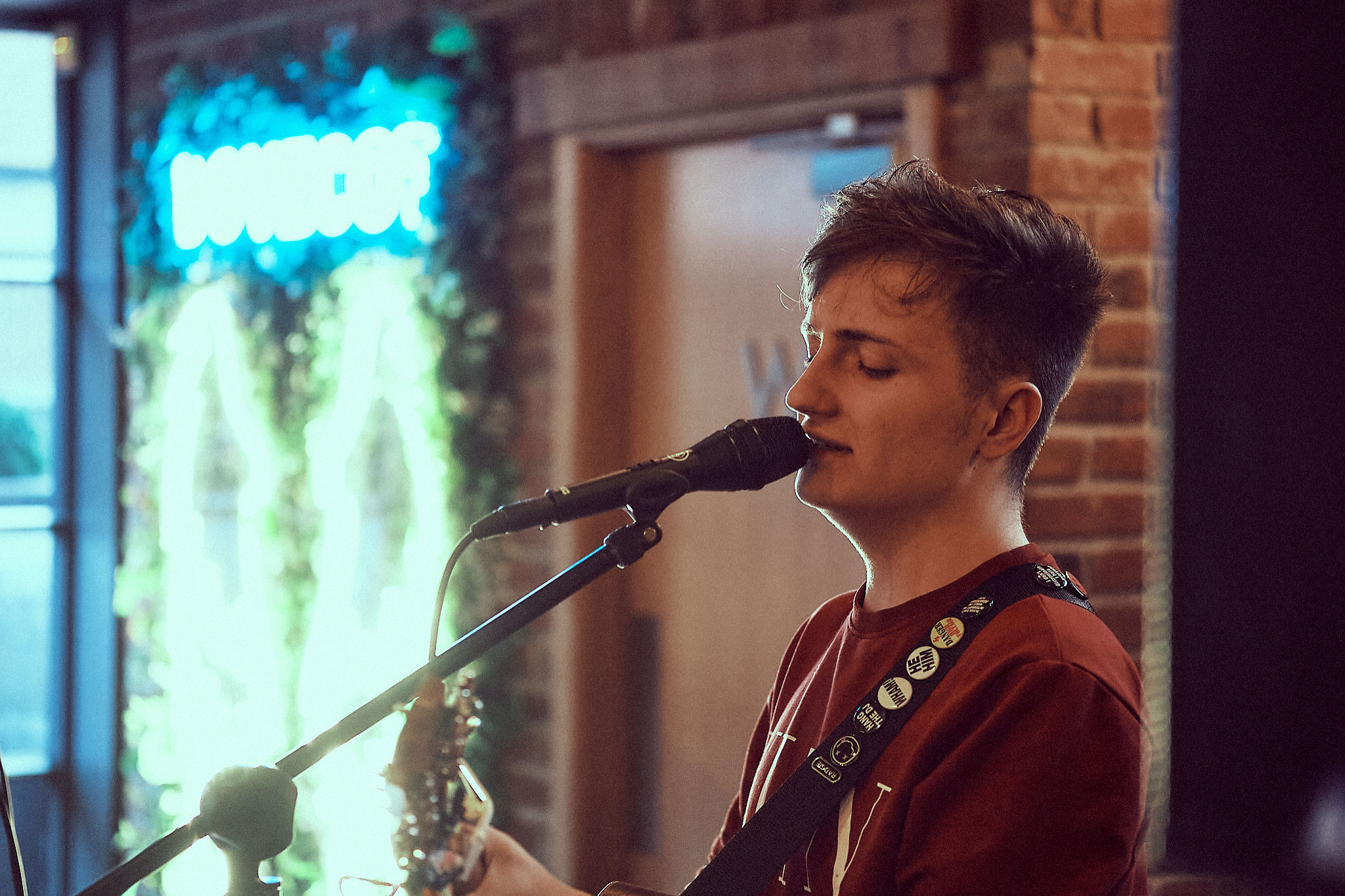 Michael Plumb singing at a live music venue