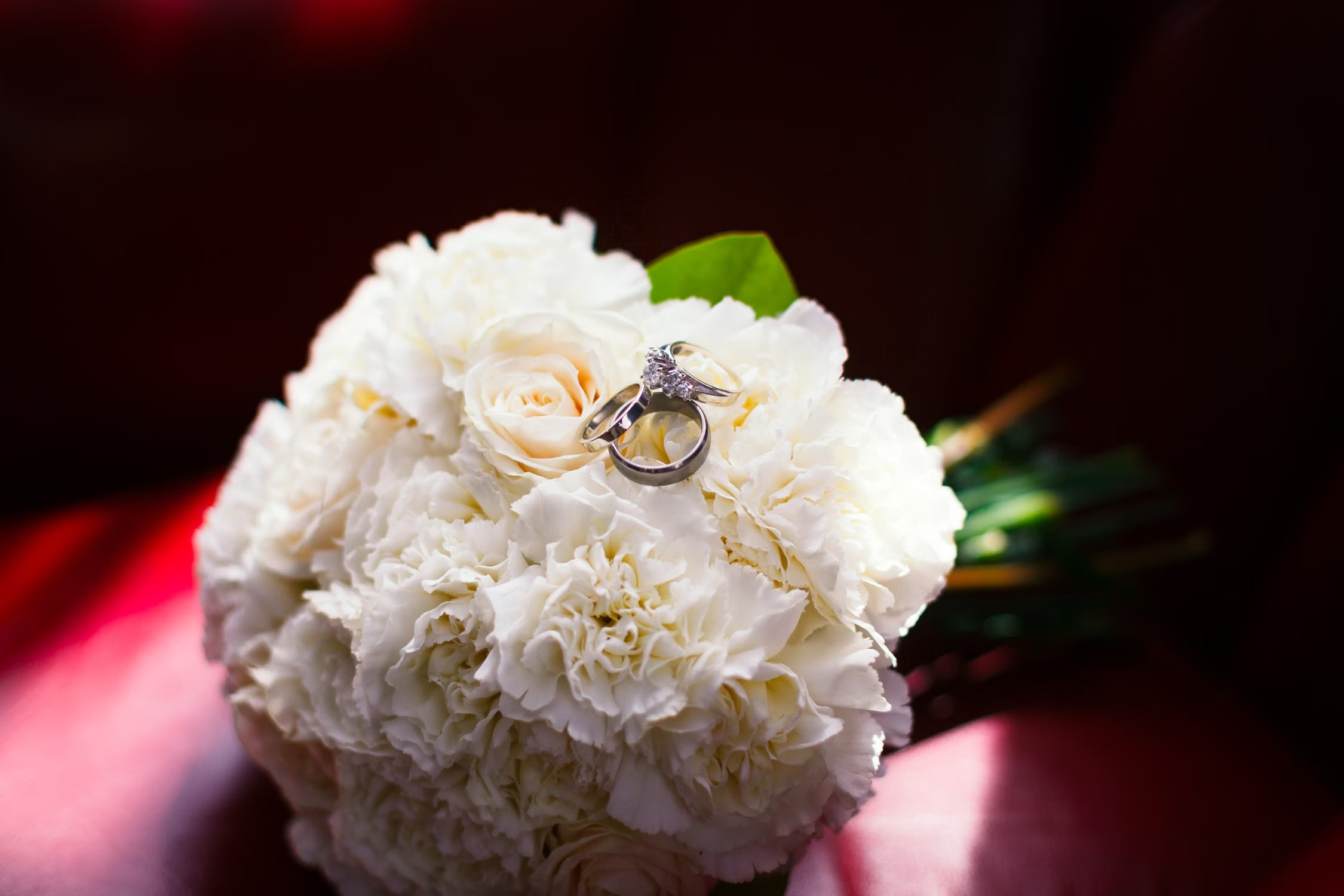 Wedding rings arranged with a bridal bouquet
